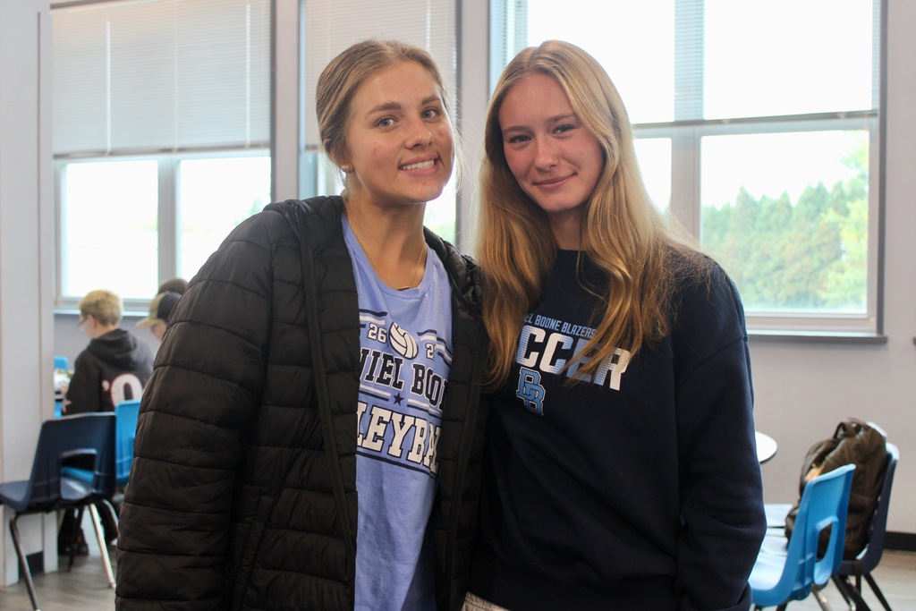 Two students showing off their Boone volleyball and soccer shirts
