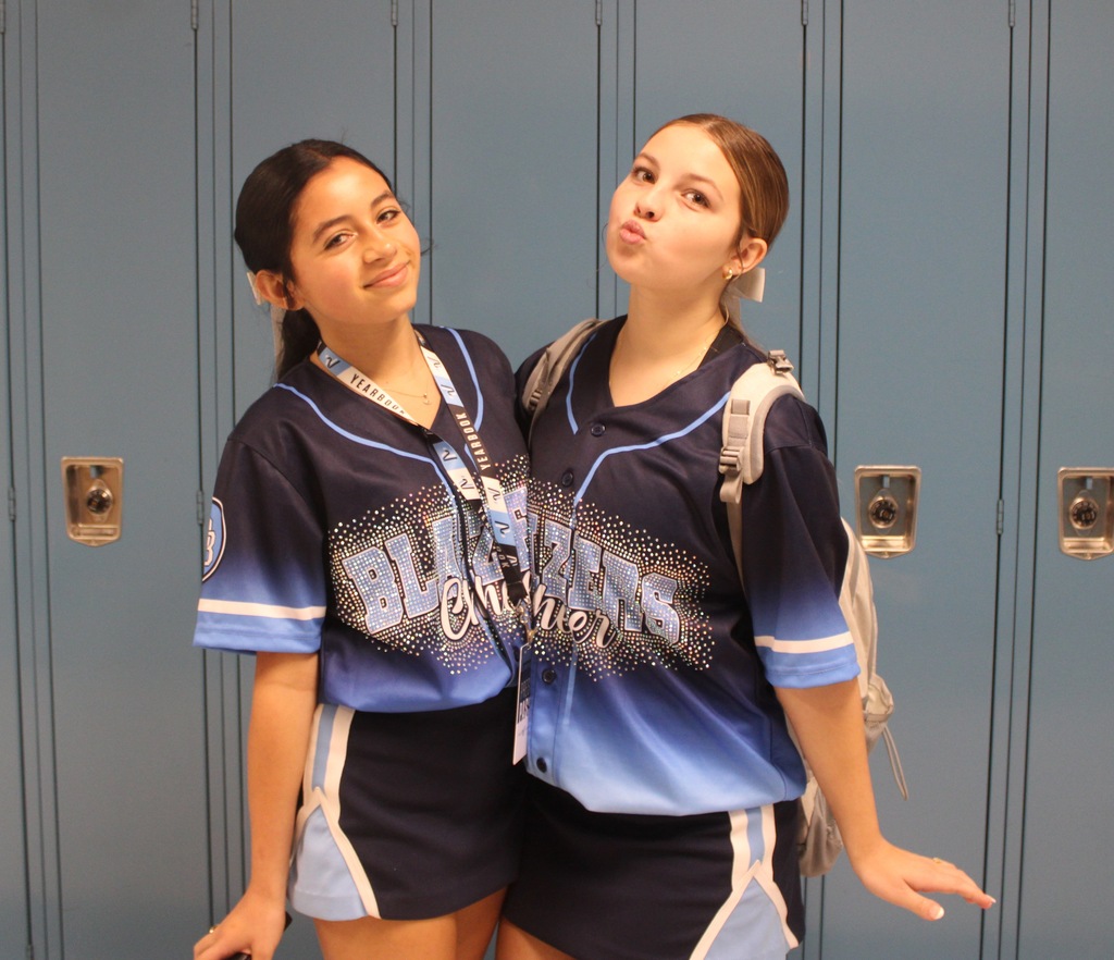 Two students showing off their Blazers Cheer jerseys