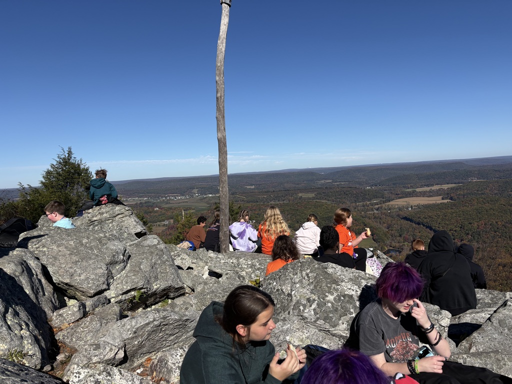 Students take in the panoramic views of the surrounding mountains and colorful autumn foliage from a rocky overlook at Hawk Mountain.