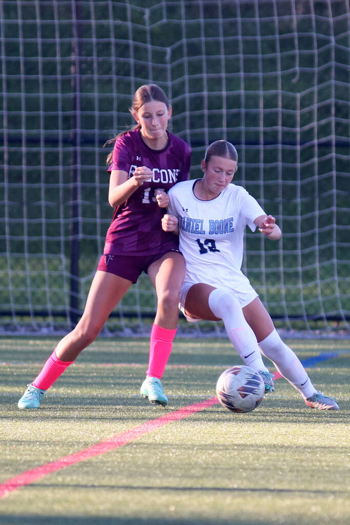 Girls soccer players from Daniel Boone and Pottsgrove battle it out for the soccer ball.