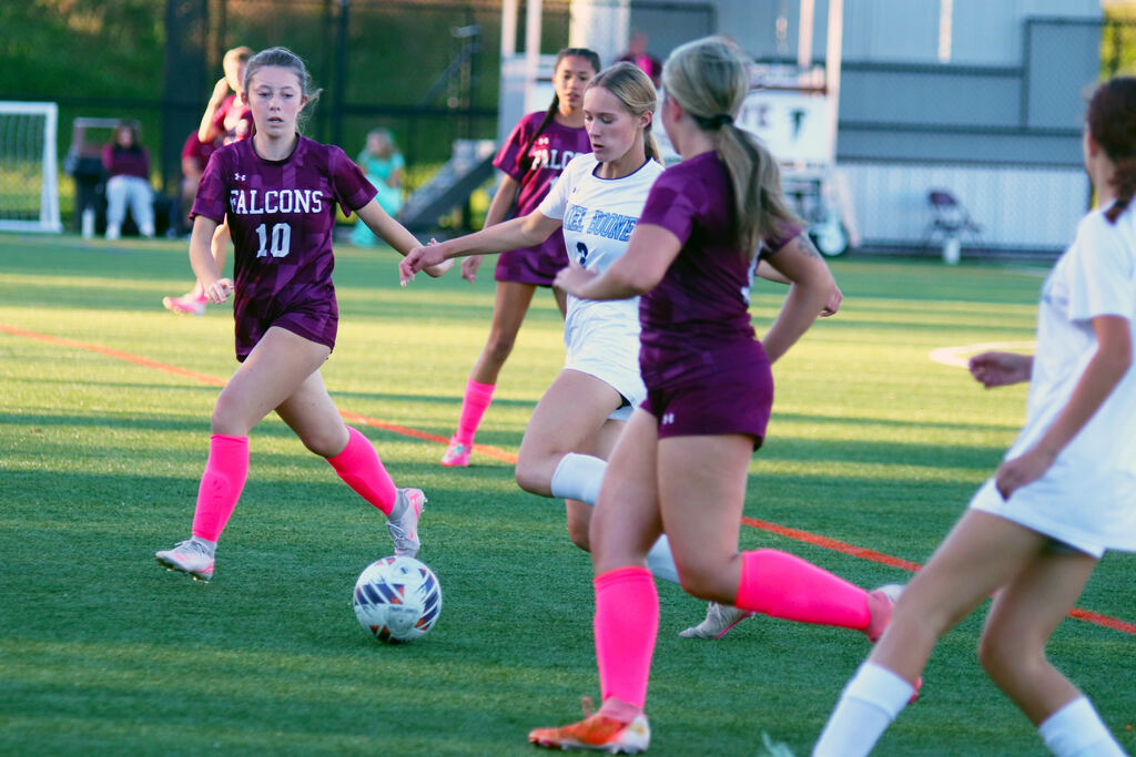 One Daniel Boone girls soccer player kicks the ball among three Pottsgrove soccer players