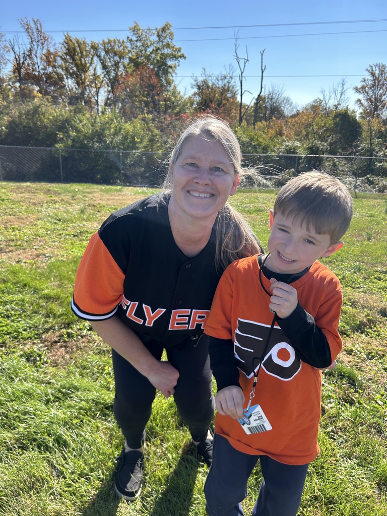 Mrs. Hefter and a student pose for the camera wearing their Philadelphia Flyers team shirts.