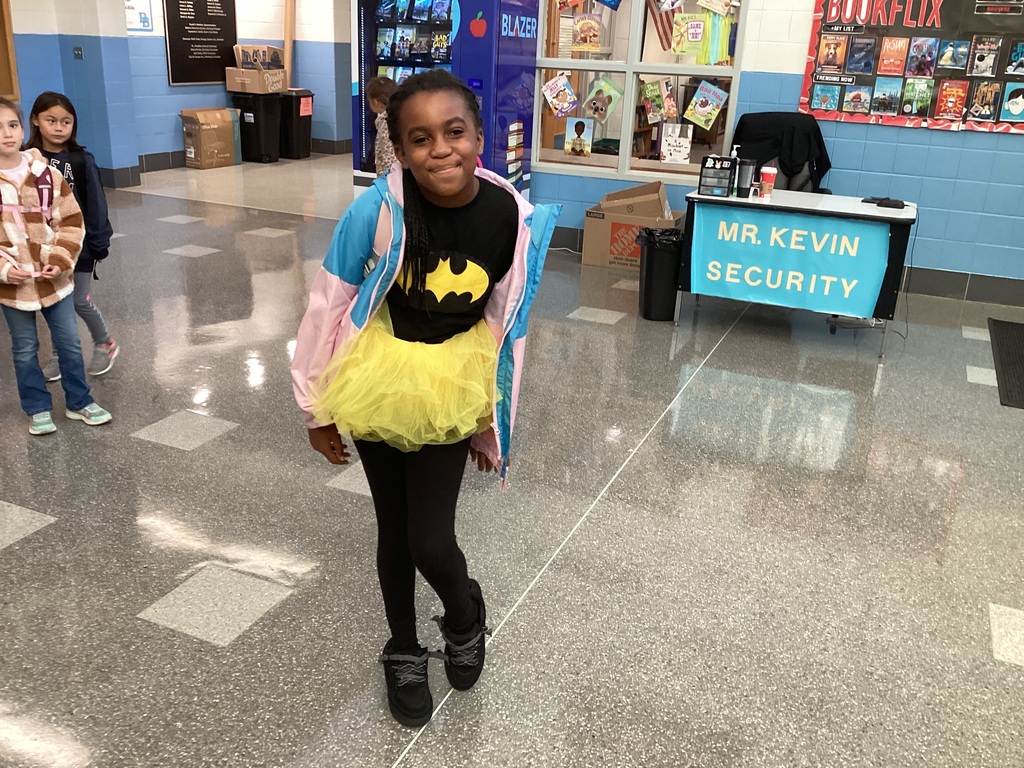 A student wearing a black batman shirt and a yellow tutu.