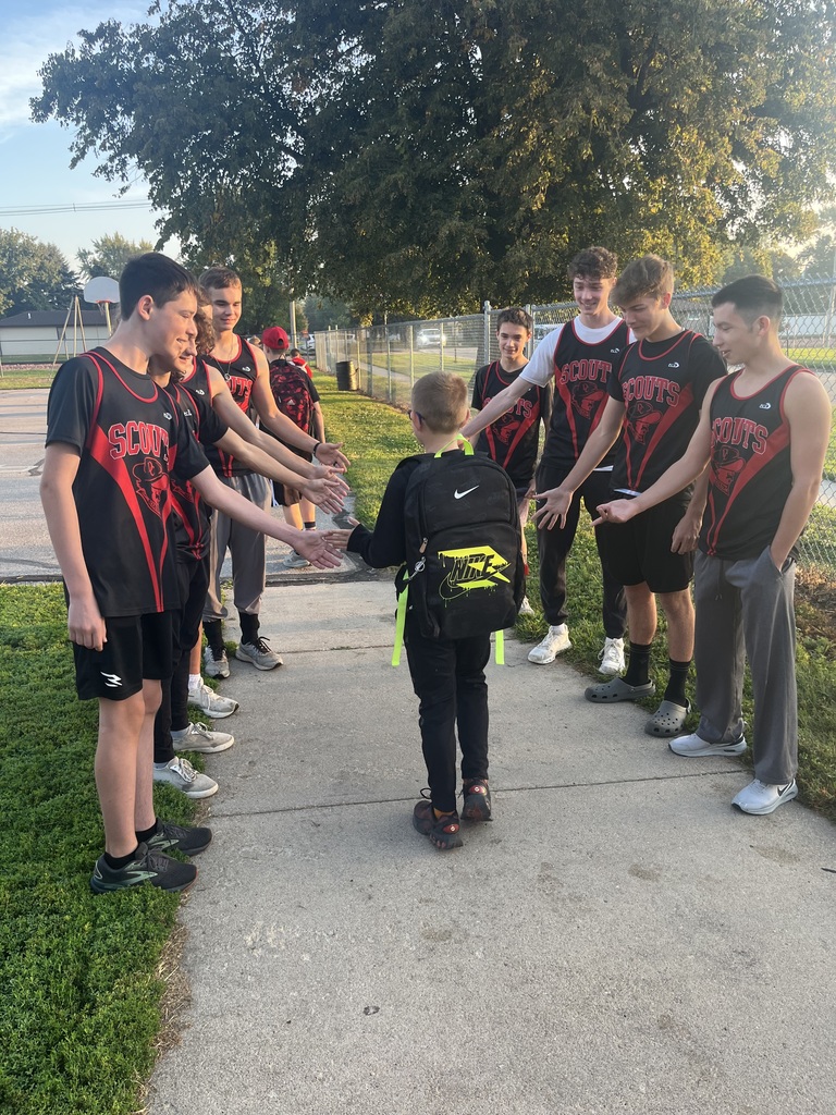 Boys Cross Country Members greeting students