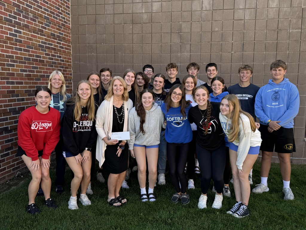 National Honor Society members presenting the check to Genesis House