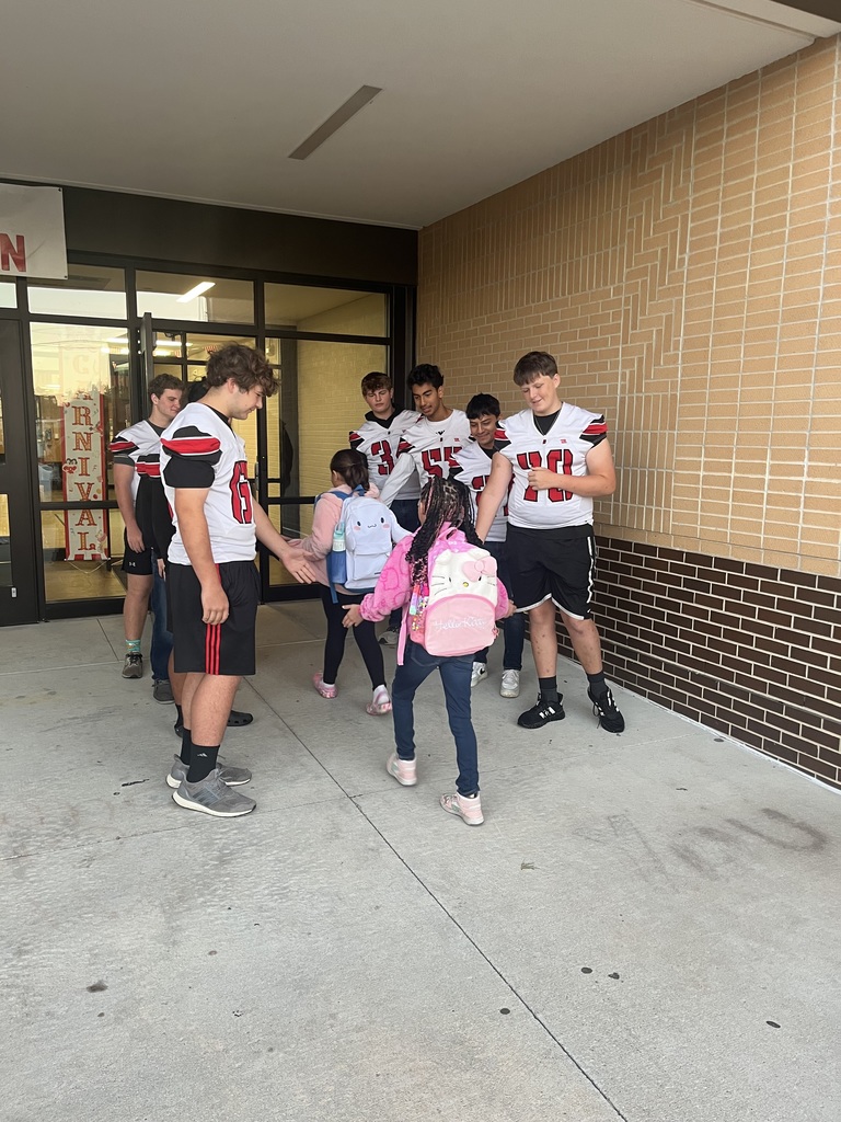 football athletes greeting students in main entrance