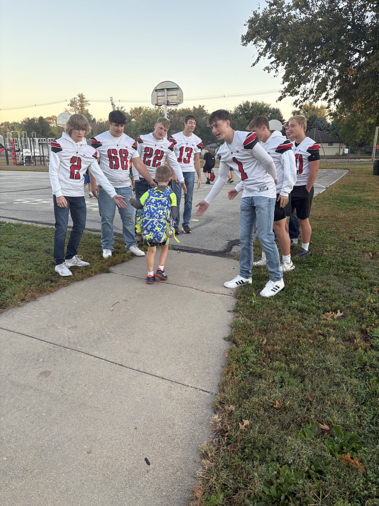 football athletes greeting students