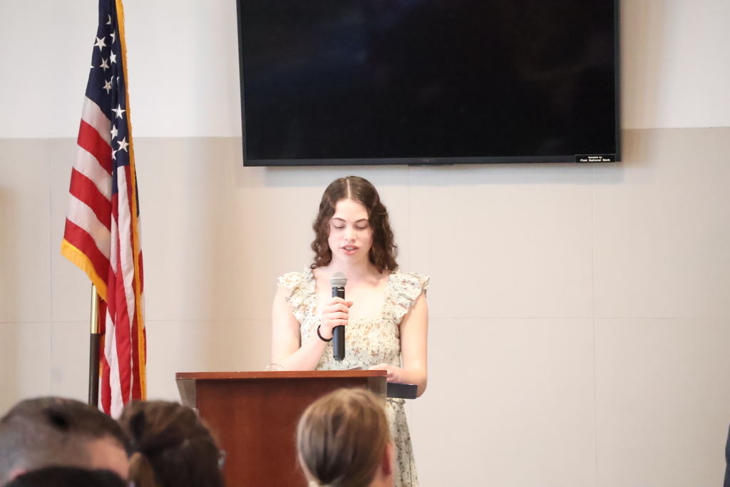 Natalia, the president, leads the induction.