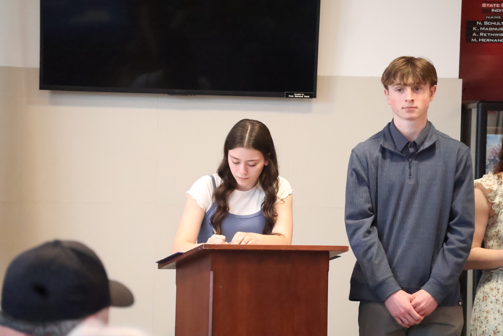 Bella signing to be officially inducted into National Honor Society.