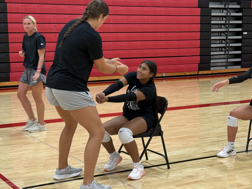 Wayne State staff assisting athletes with angle passing.