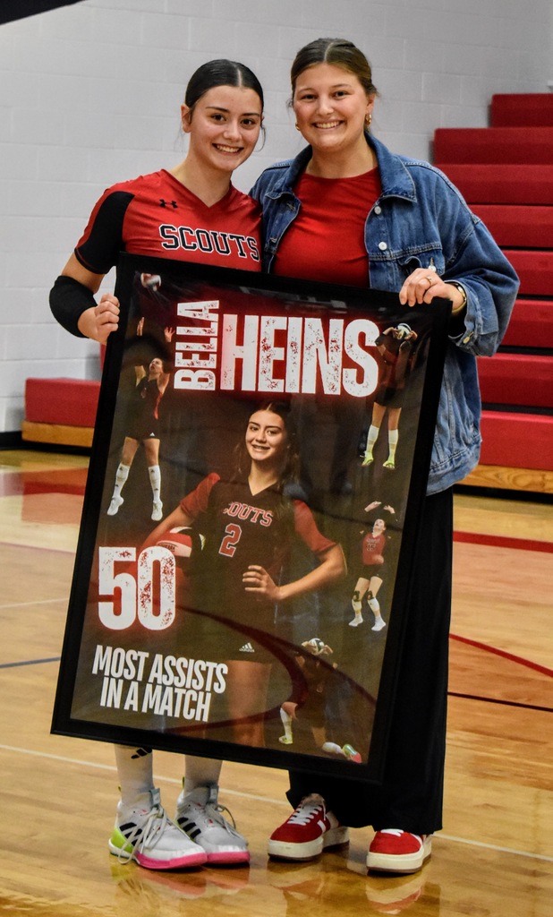 Bella being presented her record by Assistant Coach Eickmeier.