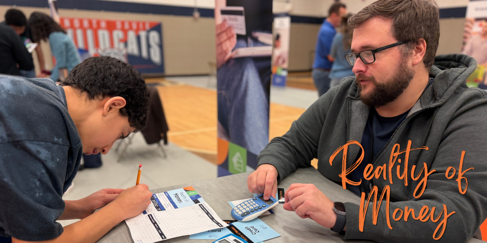 Student filling out reality of money card