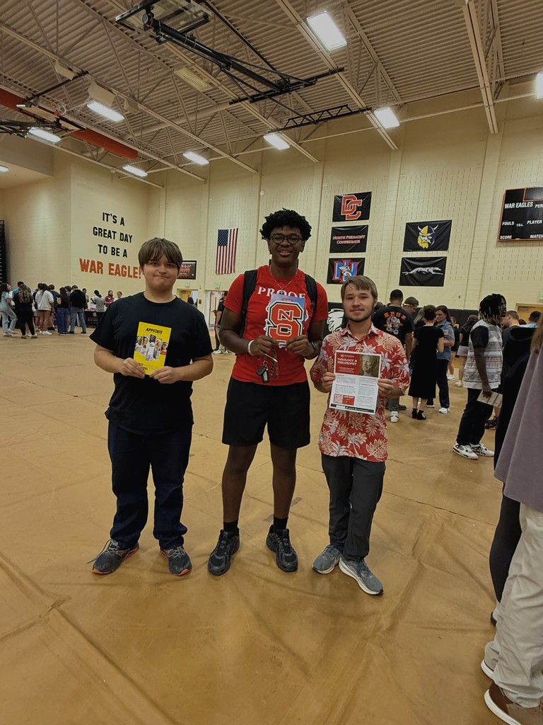 Students showing flyers from various colleges