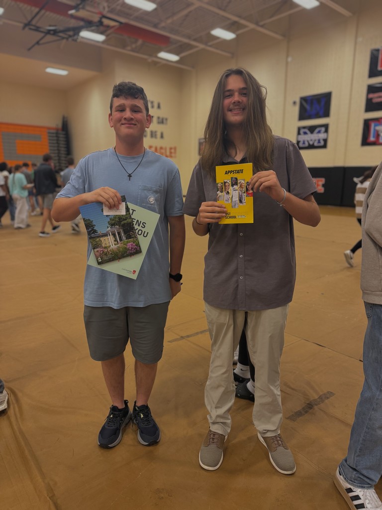 Students showing flyers from various colleges