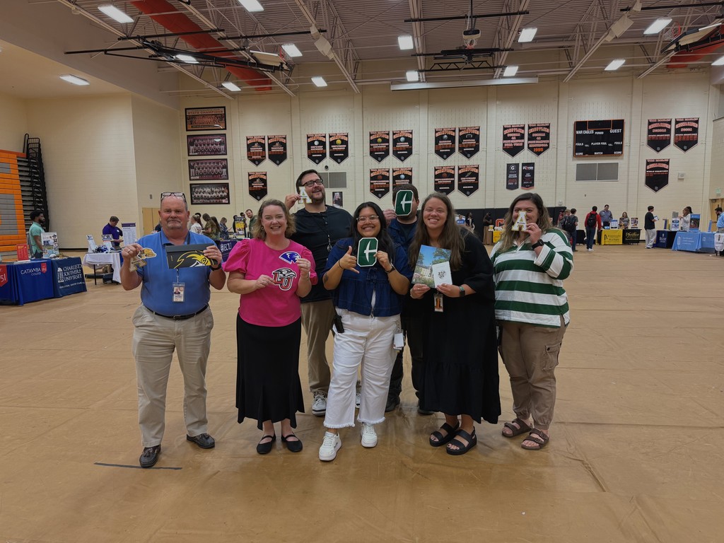 Students showing flyers from various colleges