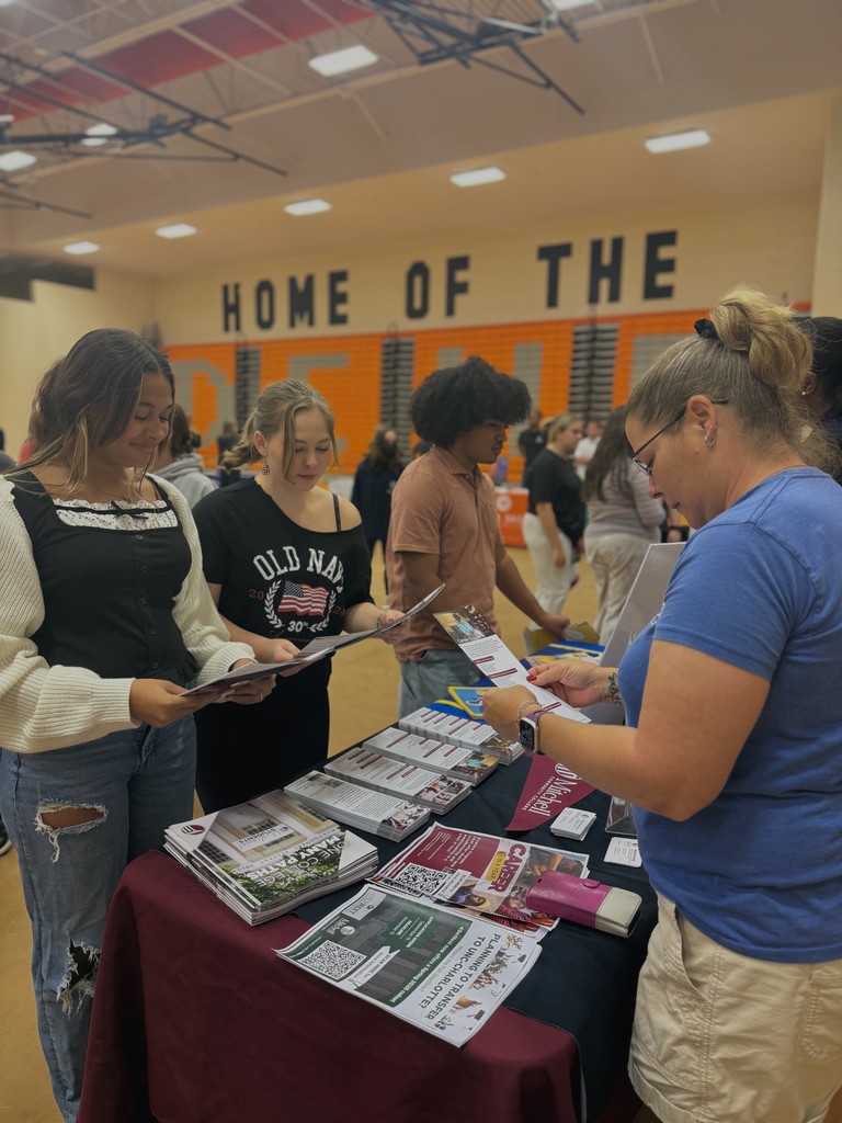 Students showing flyers from various colleges