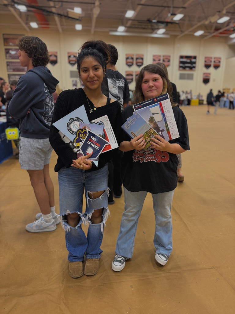 Students showing flyers from various colleges
