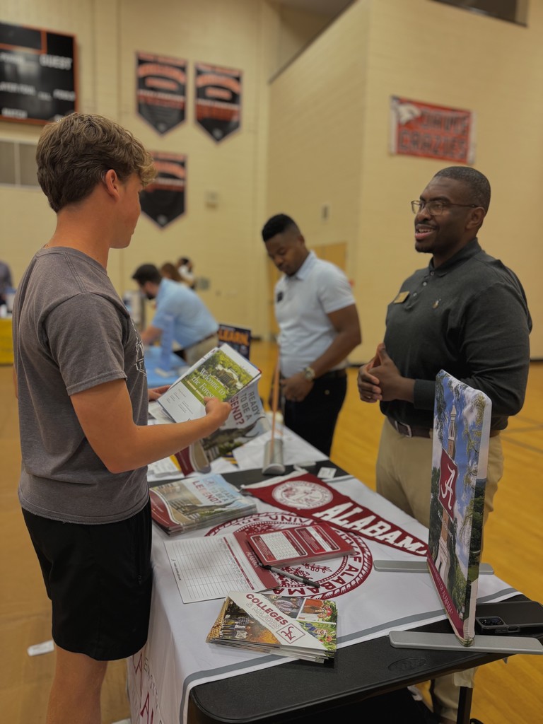 Students showing flyers from various colleges