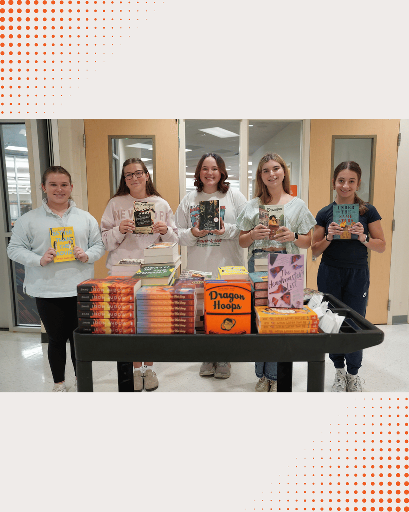 DCHS students opening boxes of newly donated books, unpacking and organizing them together