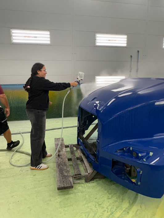 girl painting a truck