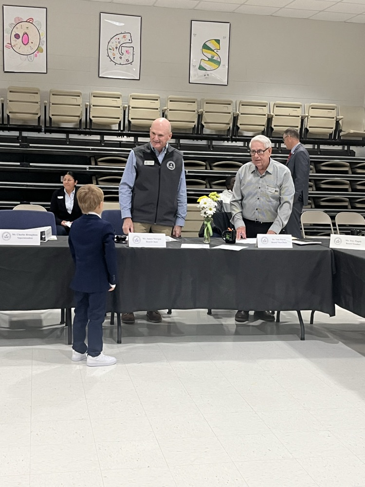 student talking to board members 