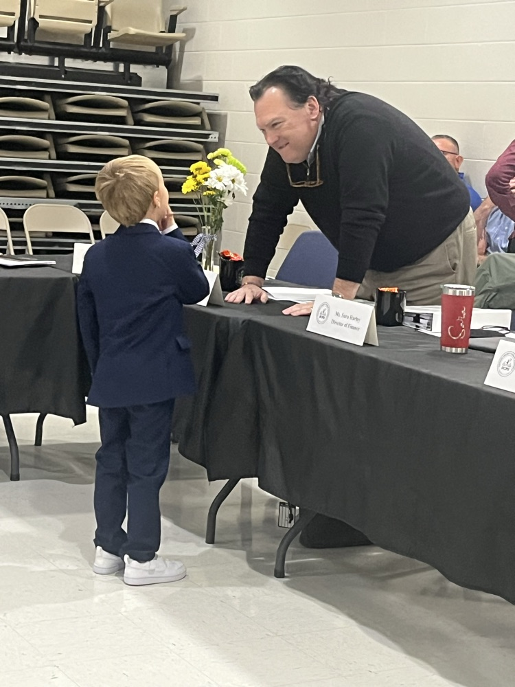 student talking to board member