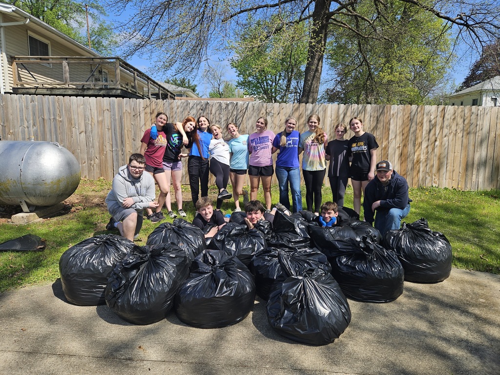 Students behind their many bags of leaves