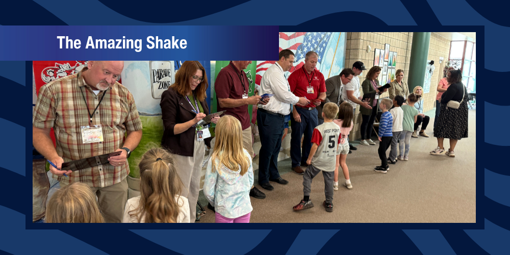 Students shaking hands with adult volunteers in the Amazing Shake Competition.