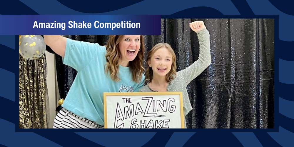 Teacher and student embrace and cheer after announcing the winner of the Amazing Shake.