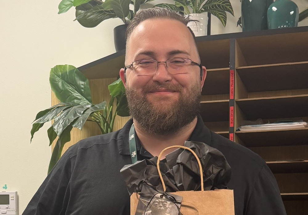 Facilities Manager holding a gift bag