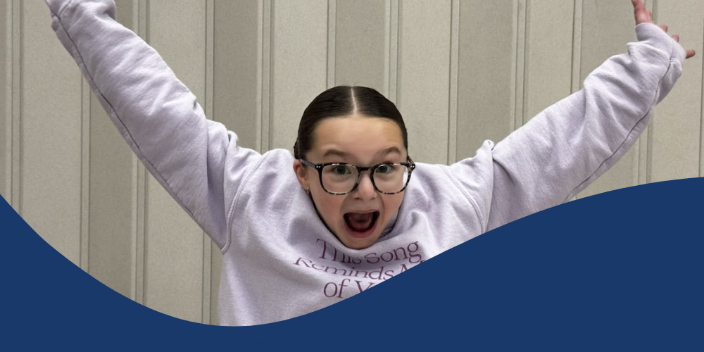 Student celebrates making it to the next round of the Amazing Shake.