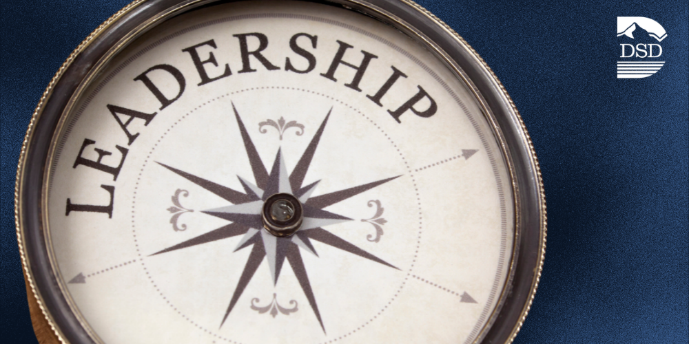 A compass with "leadership" in the middle on a blue background with the DSD logo.