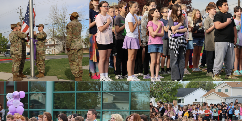 military raising the flag with students standing with hand over hearts
