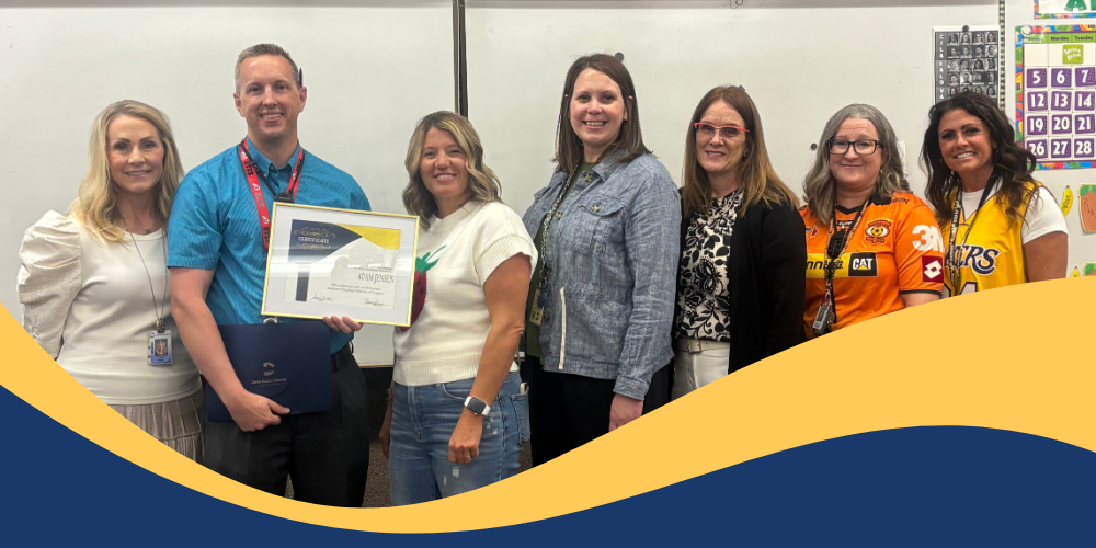 Mr. Adam Jensen poses with group after receiving an award.  