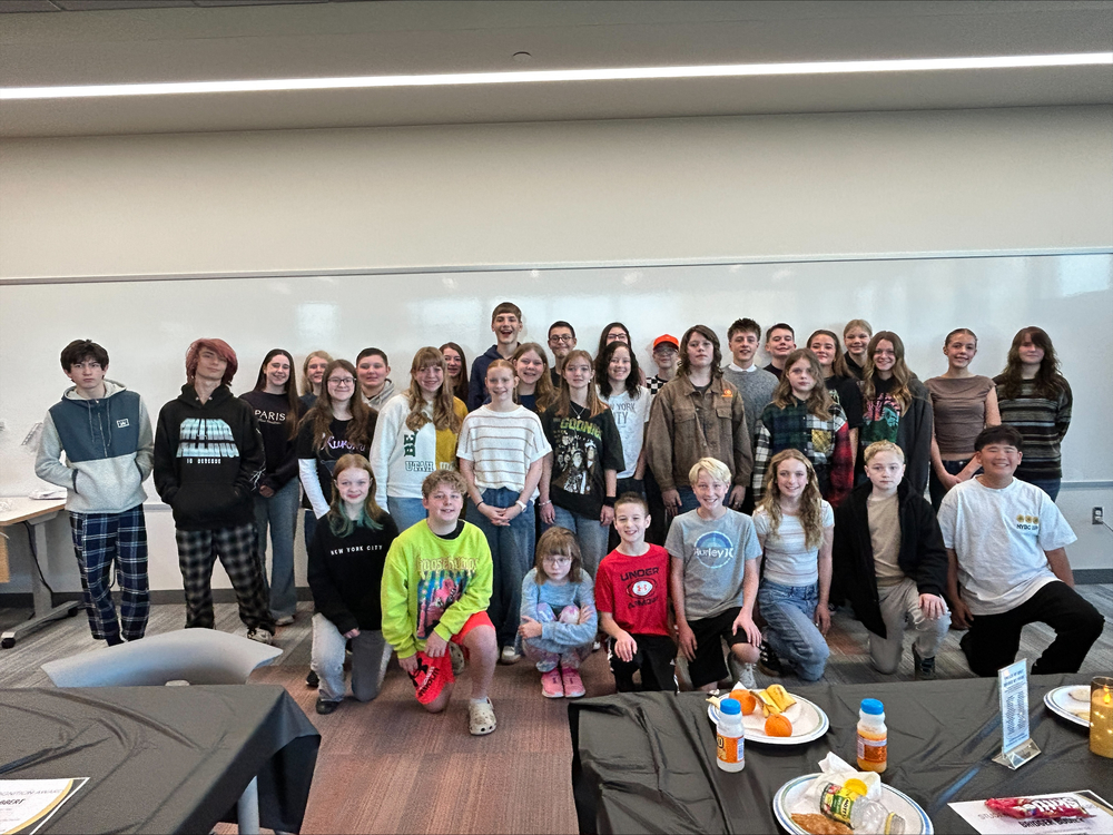 Students standing in a rows at the Student of the Month breakfast.