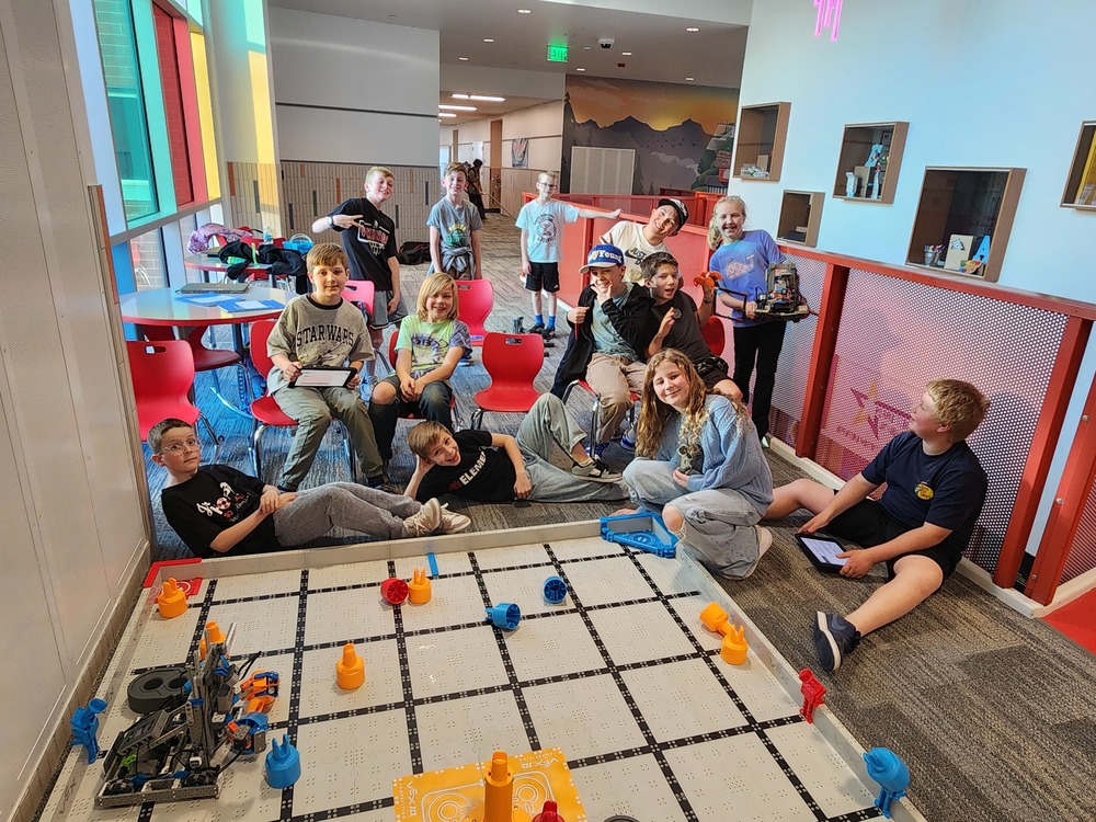 VEX students posing for a picture with their robots.