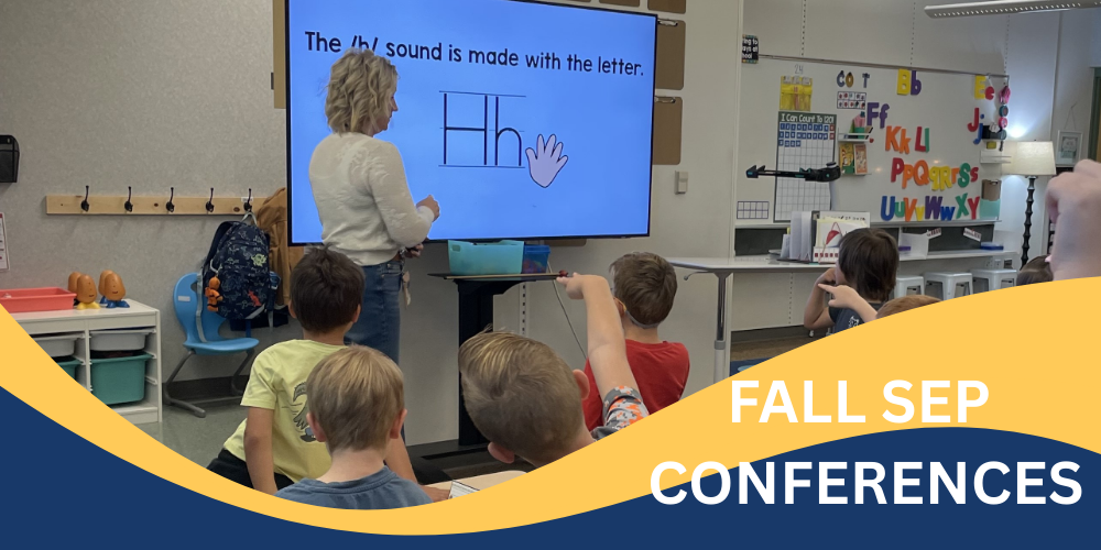 Teacher showing letter "H"