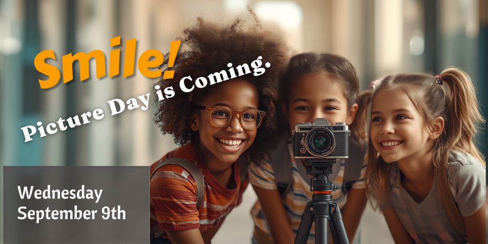 students standing behind a camera smiling