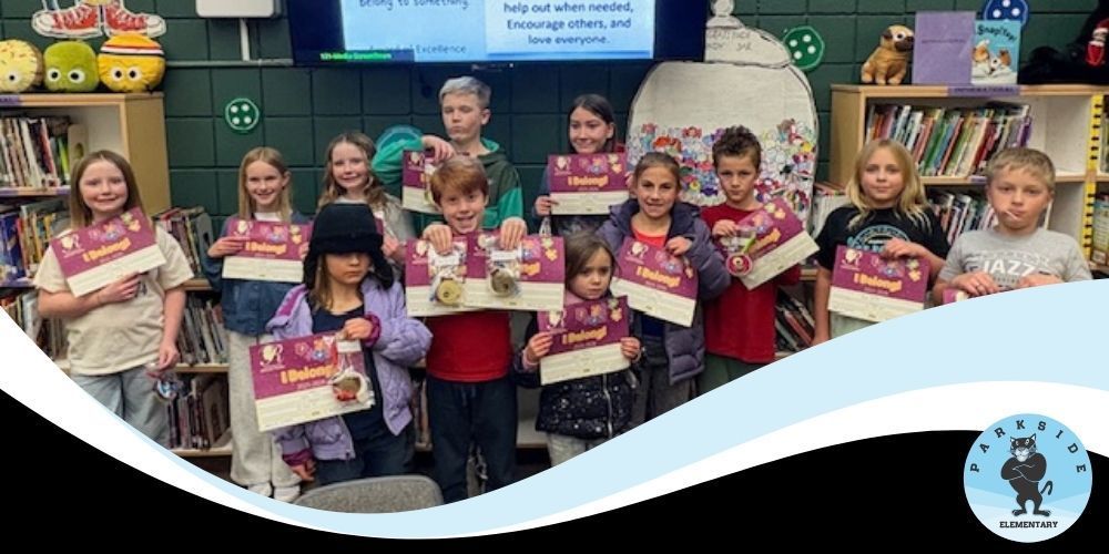 Students holding certificates from the Reflections contest. There are thirteen students shown.