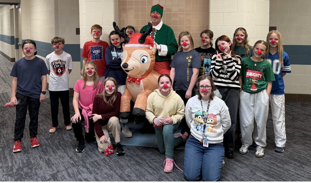 Pinky on a blowup reindeer posing with student council