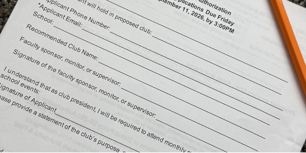 Picture of a Club Application with a pencil laying over it.
