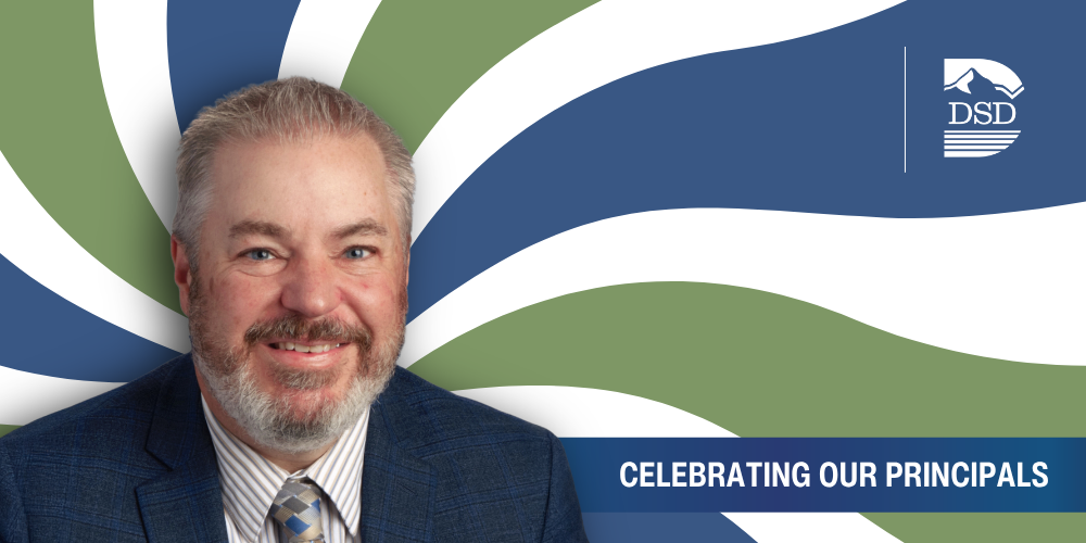 A principal in front of a wavy background with a banner that reads "Celebrating Our Principals"