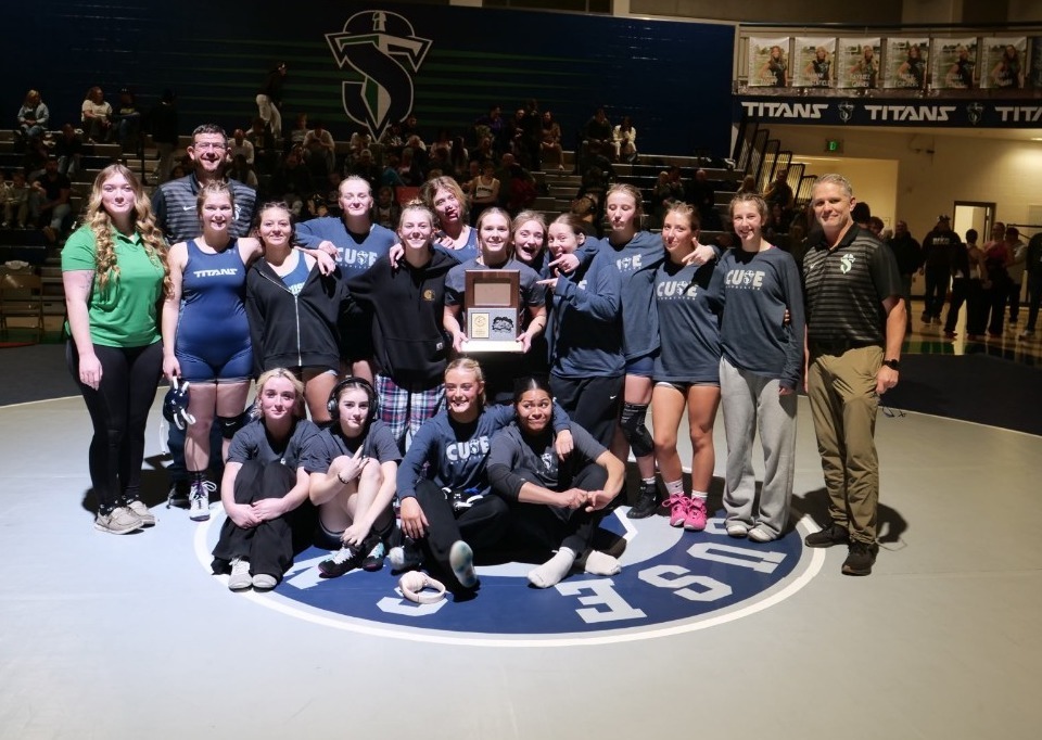Girls wrestling team picture after winning region 