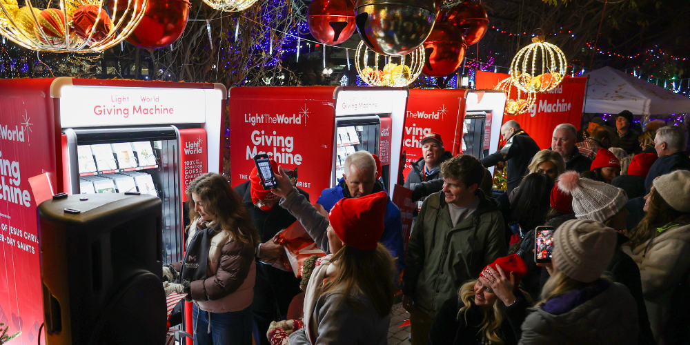 Crowd of people lined up at the Light the World Giving Machines
