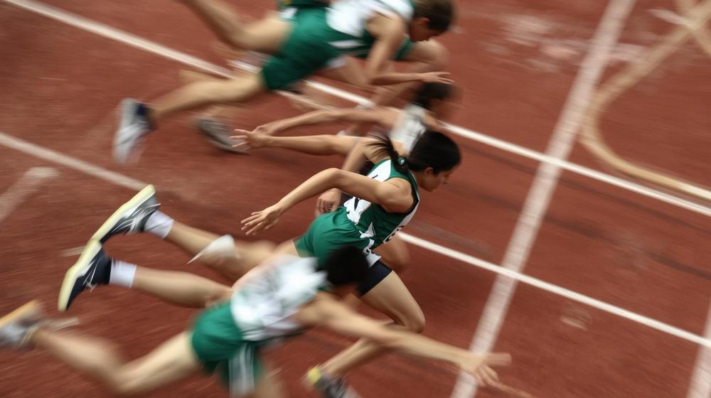 Students running track.