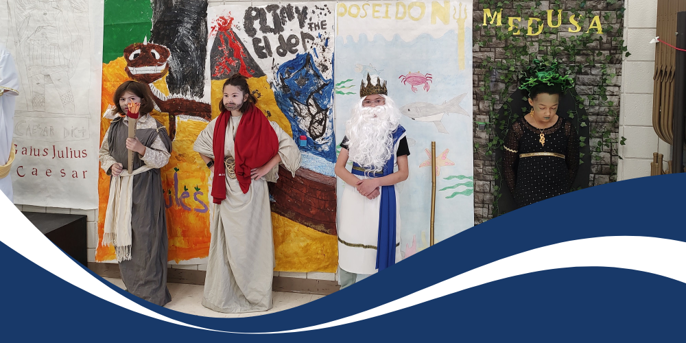 Students dressed as ancient characters with decorated backgrounds.