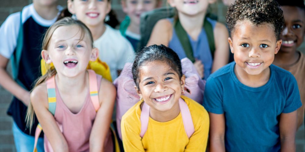 Picture of elementary age students wearing backpacks