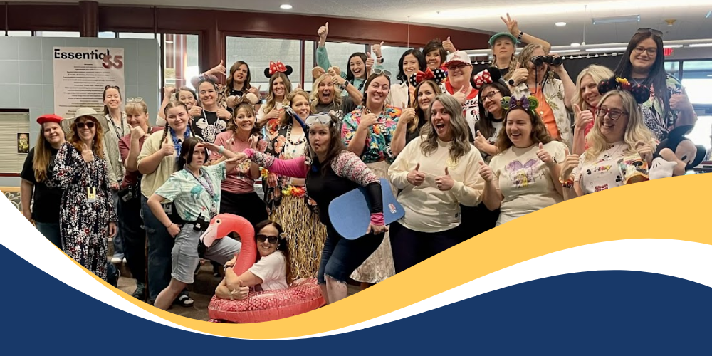 Teachers dressed for vacation posing for a picture.