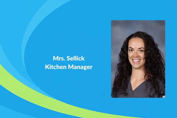 Mrs. Sellick Kitchen manager picture of women with dark hard smiling
