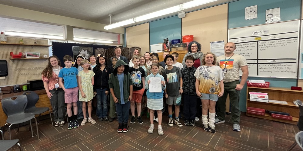 5th grade students from Ms. Burch's class standing in their classroom with Senator Todd Weiler